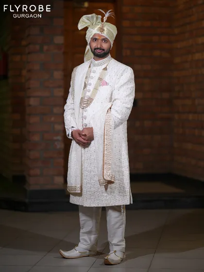 A closer look at the detailed embroidery and fit of this classic white wedding sherwani. I ensure every outfit is perfectly tailored so you look sharp from every angle.