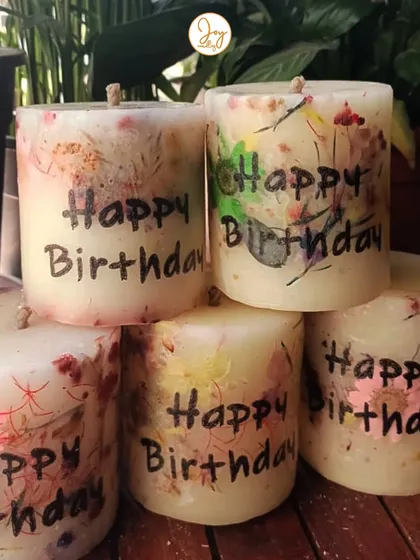 A collection of our "Happy Birthday" floral love pillar candles. A client ordered these to have thoughtful, handmade gifts ready for her friends' special days.