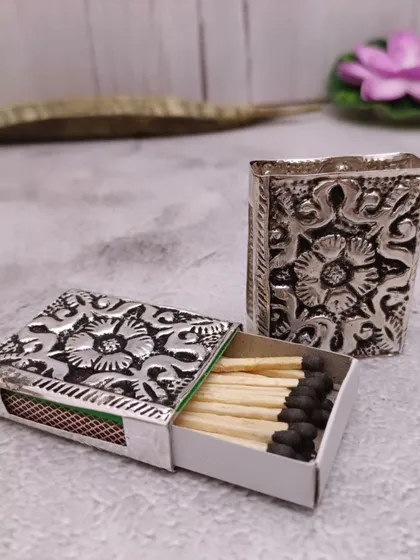 A German silver matchbox cover with intricate floral carvings, a unique and elegant accessory for your pooja room.