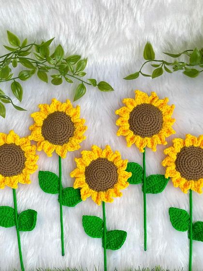 The individual handmade sunflowers before they were wrapped. They look like a little field of sunshine lying on the soft white fabric.