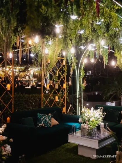 A closer look at the lounge area, showing the custom-designed cushions and the interplay of candlelight and hanging foliage. Every layer of decor is thoughtfully considered to build a rich, textured look.