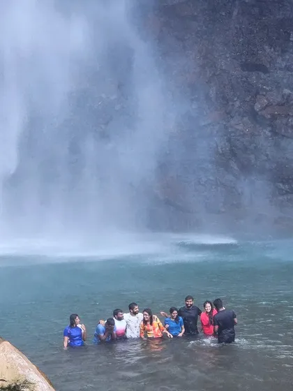 The group enjoying a swim in the powerful currents of a waterfall pool.