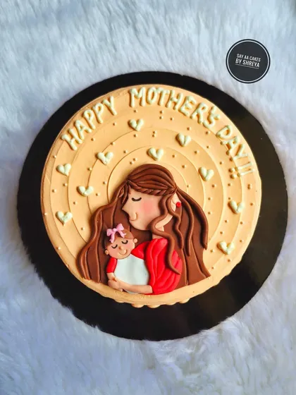 A sweet and simple cake to celebrate Mother's Day. The design features a beautiful illustration of a mother holding her child, surrounded by hearts, expressing the sweetness of a mother's love.