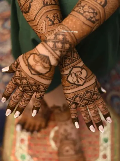 A close-up on a design featuring personalized initials 'R' and 'K' within ornate frames, surrounded by jaali work.