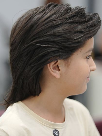 The side view of this classic boy's haircut shows the soft layers and clean lines.