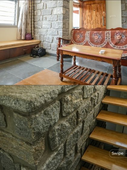 A cozy seating area in the Shashidhar Residence, with a built-in wooden bench next to a stone pillar, creating a perfect spot to relax.
