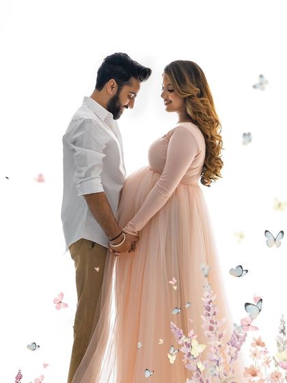 A slightly closer view of a tender moment between the couple. The soft lighting and whimsical elements make this pregnancy portrait feel like a page from a storybook.