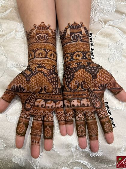The timeless beauty of peacocks and elephants comes together in this classic Indian mehendi design.