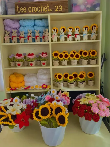 A snapshot of a large dispatch, featuring potted sunflowers, amigurumi bunnies, and bouquets of roses.