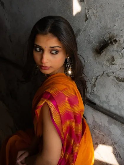 A look back, framed by the shadows of a narrow passage. This creates a sense of mystery and depth.