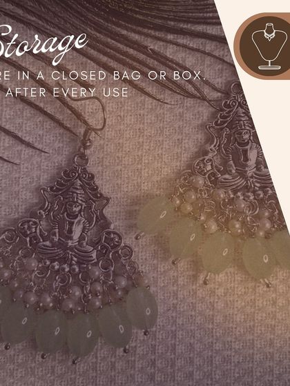 A beautiful pair of silver-tone temple earrings featuring a Goddess Lakshmi motif. I've added light green beads and pearls to give them a soft, divine look. Remember to store them in a closed box to keep them safe.