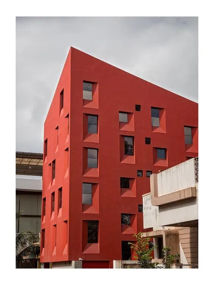 Completed in 2016, this student housing project explores density on a minimal footprint of just 111.5 sq.m. The seemingly random fenestration is a direct outcome of the building's internal section and spatial layering.