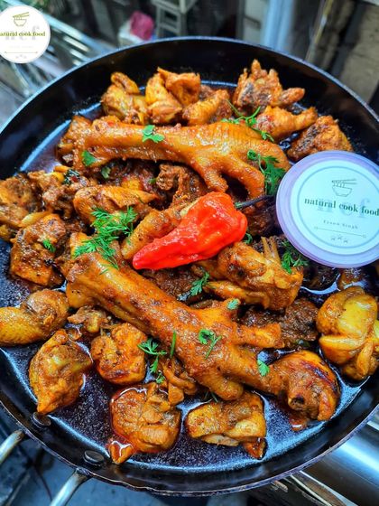 My country chicken curry, complete with chicken feet and a fiery king chili.