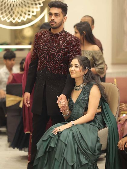 A candid moment from Bhumika's cocktail party. She looks effortlessly chic in her emerald green saree, with makeup that's perfect for the evening lights.