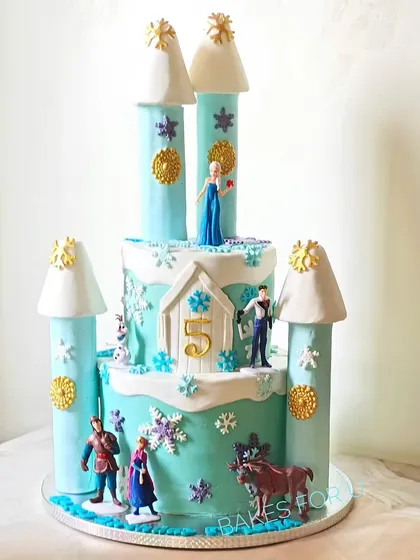 A grand Frozen castle cake, complete with towers and all the main characters. This intricate design is perfect for creating a winter wonderland at a child's birthday party.