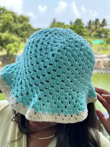A customer enjoying her two-toned bucket hat. The breathable granny stitch pattern makes it comfortable to wear even in warm weather.