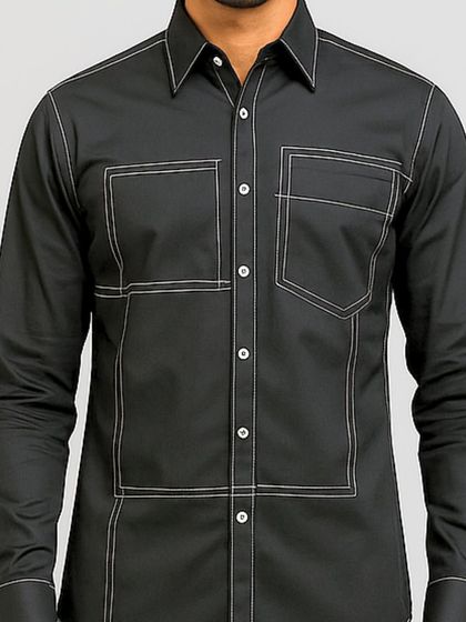 A close-up of the torso, focusing on the geometric stitching and the dual chest pockets. The precision of the lines gives the shirt a clean, architectural feel.