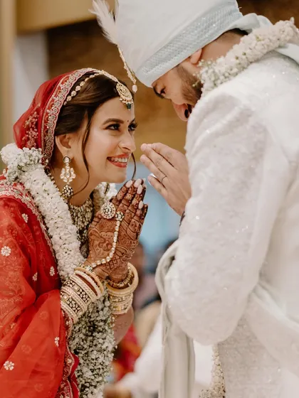 A moment of mutual respect and love during the wedding ceremony. The bride's joyful expression as she greets her groom is a beautiful, candid memory.