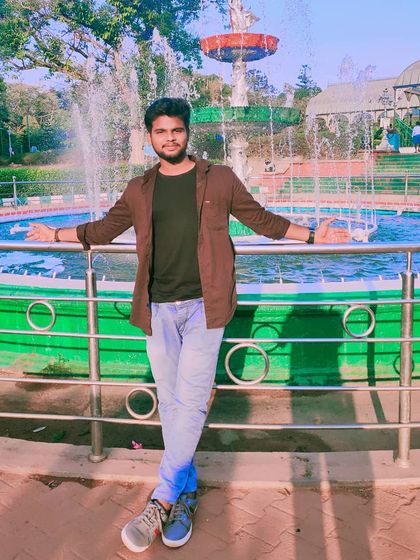 In front of the fountain at a city park, possibly Lalbagh or Cubbon Park.