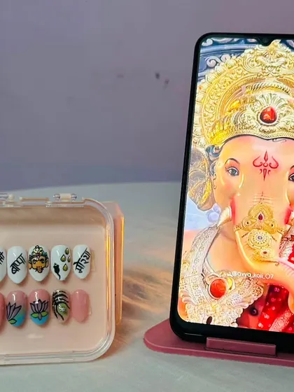 Creating these Ganpati-themed nails was a truly special experience. Each nail is hand-painted with details like a Ganesha portrait, lotus flowers, and auspicious symbols, making it a wearable piece of art for the festival.