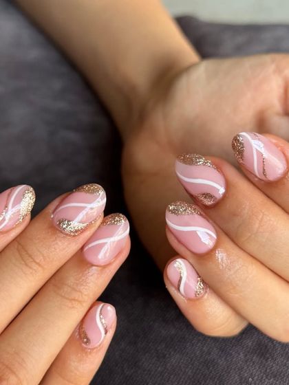 A full view of the pink, white, and gold swirl nails. This design is both playful and elegant.