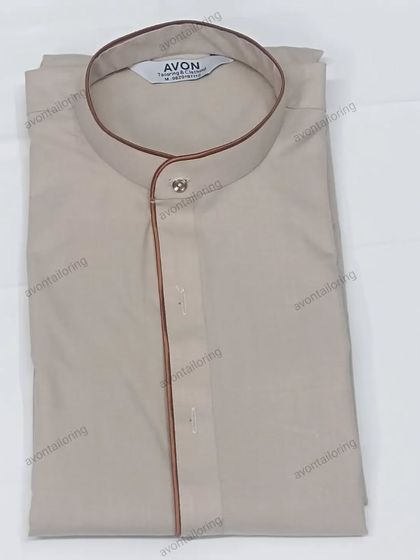 This is a colored piping kurta, which comes as a full set with a saya and izaar. The brown piping on the beige fabric creates a subtle and classic contrast.