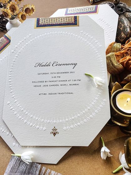 An elegant and understated invitation for a Haldi ceremony, featuring beautiful embossed details and a touch of traditional pattern.