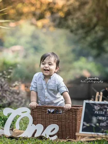 A big, happy grin from the birthday boy during his outdoor session. The natural setting brings out his joyful spirit.