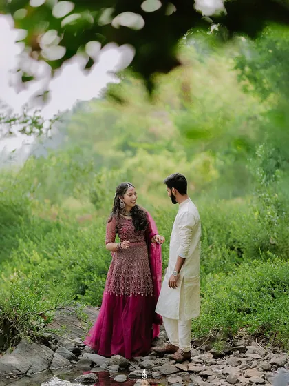 A candid conversation framed by overhanging leaves. This technique creates a sense of intimacy, as if we are peeking into a private moment.