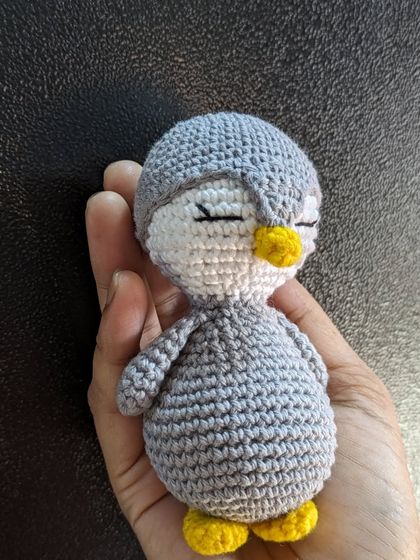 A simple, sleepy penguin without any accessories, held in my hand.