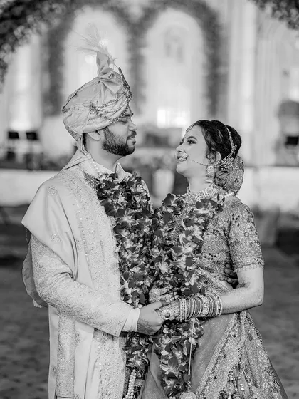 A timeless black and white portrait of the couple sharing a happy, loving gaze.