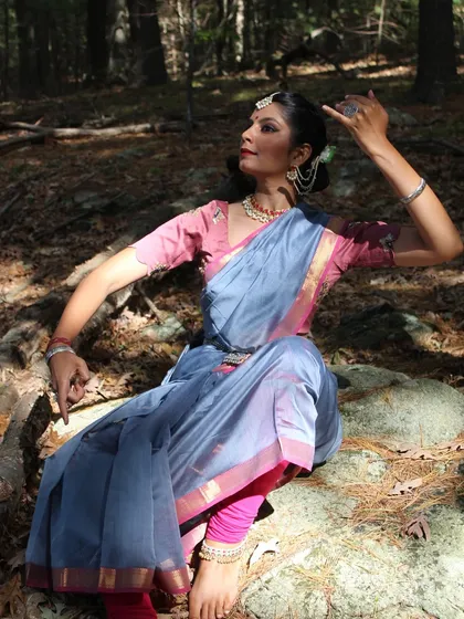 A graceful, seated pose in the woods, part of a brand collaboration that blended the beauty of the saree with the expressiveness of Kathak.