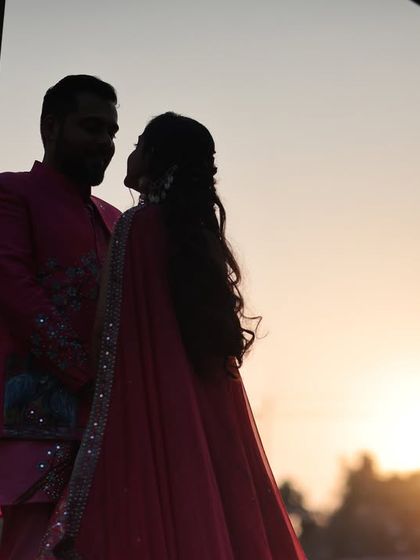 Another beautiful sunset silhouette shot of the same couple. This wider angle shows more of the environment while still maintaining that incredibly romantic and intimate feel.