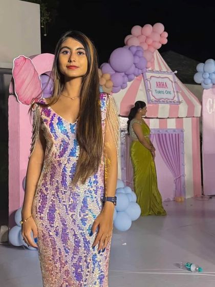 A custom creation for a truly unforgettable birthday girl. This iridescent sequin gown with draped pearl shoulders was designed to match her joyful and elegant spirit.