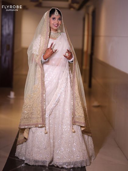 An all-white chikankari lehenga for the bride who defines elegance. This look is perfect for a day wedding or an Anand Karaj ceremony, offering a serene and sophisticated vibe.