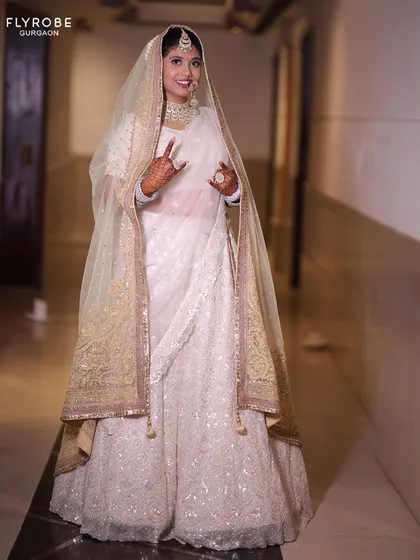 An all-white chikankari lehenga for the bride who defines elegance. This look is perfect for a day wedding or an Anand Karaj ceremony, offering a serene and sophisticated vibe.
