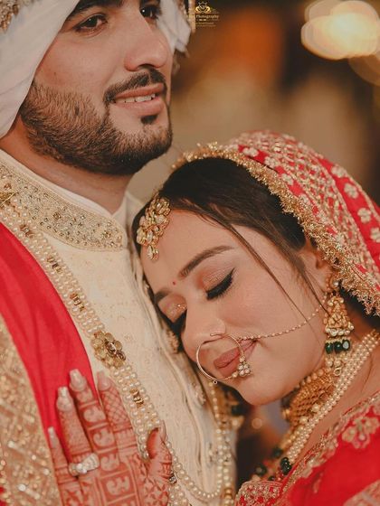 An intimate and emotional close-up. She looks so peaceful and happy resting her head on her groom's shoulder.