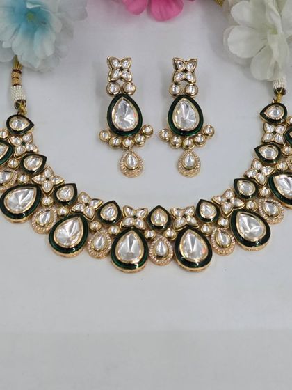A simple and elegant Polki necklace set with green enamel work, perfect for a bridesmaid or a pre-wedding function.