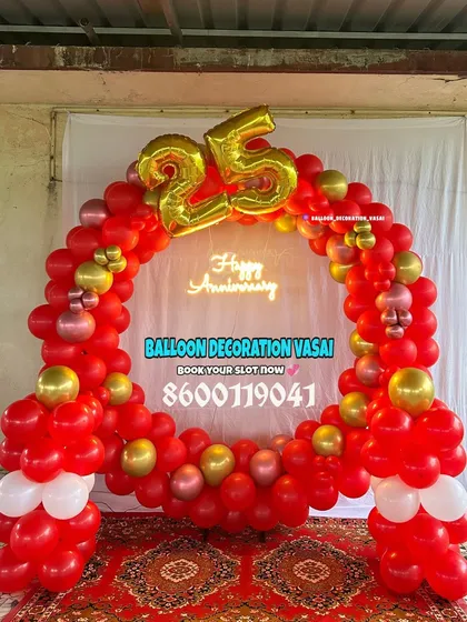 A vibrant red and gold balloon ring for a 25th-anniversary celebration. The "Happy Anniversary" neon sign and large foil "25" make it a festive and bold statement piece.