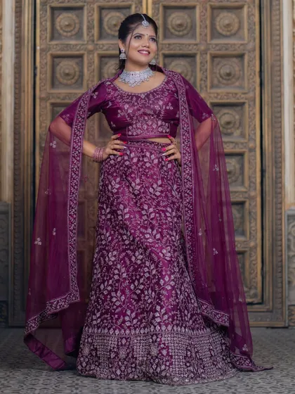 A happy and smiling portrait in a purple lehenga. The makeup is designed to look great in photos.