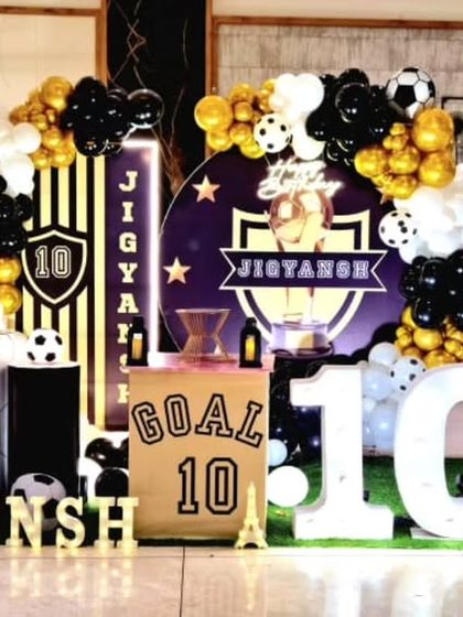 A dynamic football-themed 10th birthday party with a custom backdrop, goal post prop, and large marquee numbers.