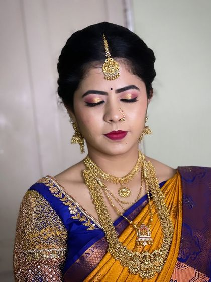 A close up on the eye makeup for this bride. I used a blend of gold and pink shimmer with a sharp wing, paired with a bold red lip for her wedding ceremony.
