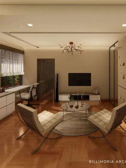 This spacious bedroom combines a sleeping area with a comfortable lounge and a dedicated workspace. The neutral color palette and warm wooden flooring create a cohesive and relaxing environment.