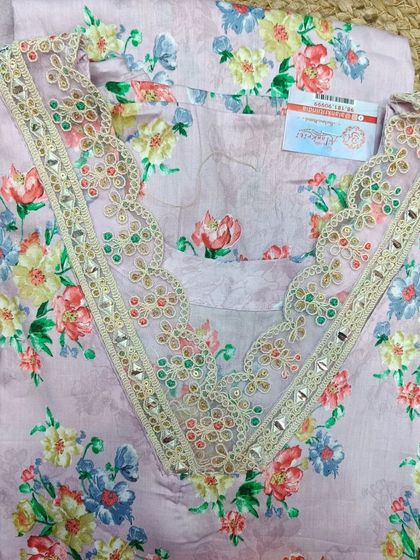 This cotton unstitched suit piece features a lovely lavender floral print and a pre-embroidered neckline. I offer customized stitching for all my suit fabrics.