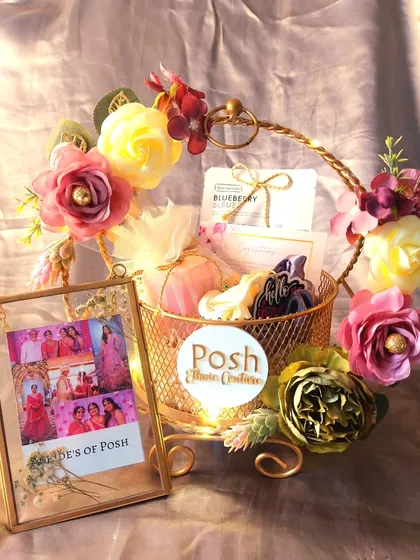 A full view of the wedding gift we created for a bridal boutique's client. The hamper includes a custom photo frame and other small gifts, all beautifully arranged in a floral metal basket.