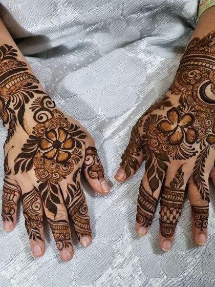 The same beautiful Arabic design, showing both hands together. The asymmetrical patterns on each hand add to its unique charm.