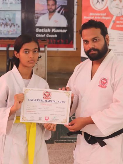 Another successful student receiving her yellow belt certificate. Our classes have a good mix of boys and girls, all learning and growing together in a supportive environment.