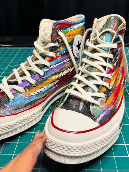 A close-up showing the texture and layers of paint on the boho-inspired custom Converse.