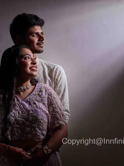 A creative portrait using a single beam of light to highlight the couple. This technique creates a sense of drama and intimacy, perfect for a unique engagement photo.