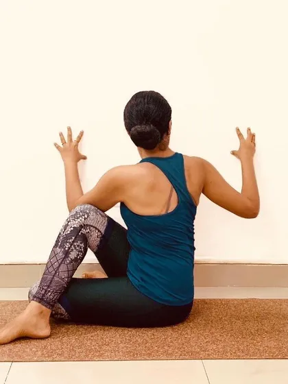 The wall is one of our best props. Here, it's used to deepen the twist in Ardha Matsyendrasana, providing leverage to rotate the torso while keeping the spine long and supported.